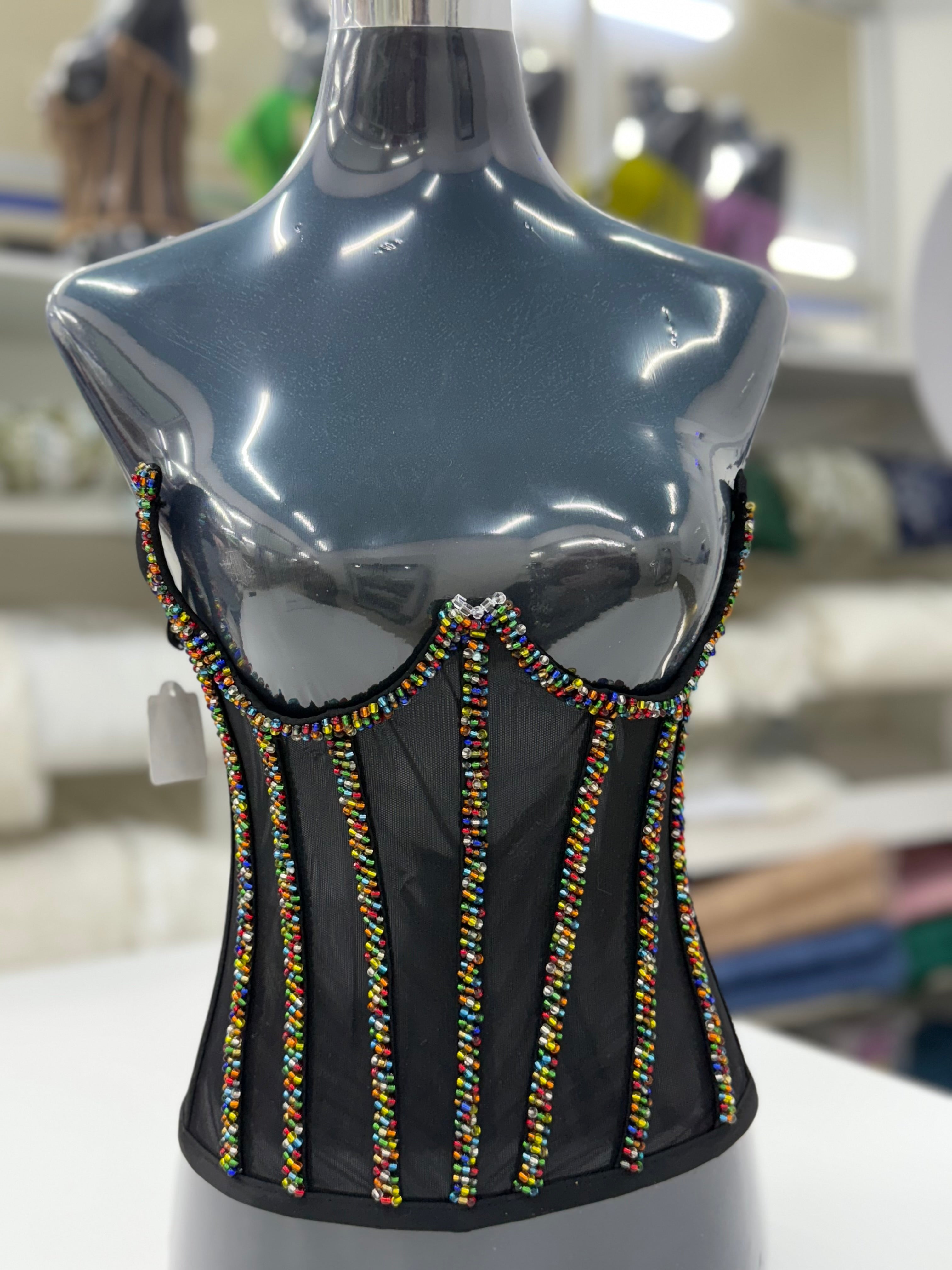 Black mesh corset adorned with vibrant African-inspired beadwork.